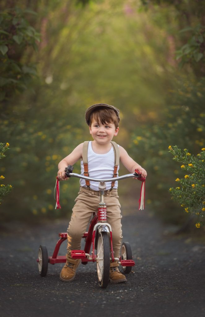 Perth boy riding a tricycle during outdoor photo session