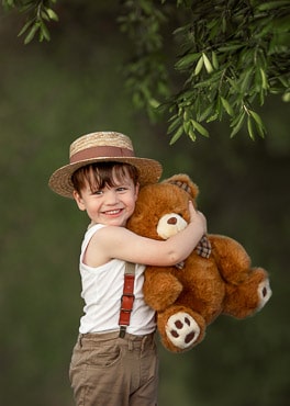 Perth toddler holding a teddy bear during outdoor photo session