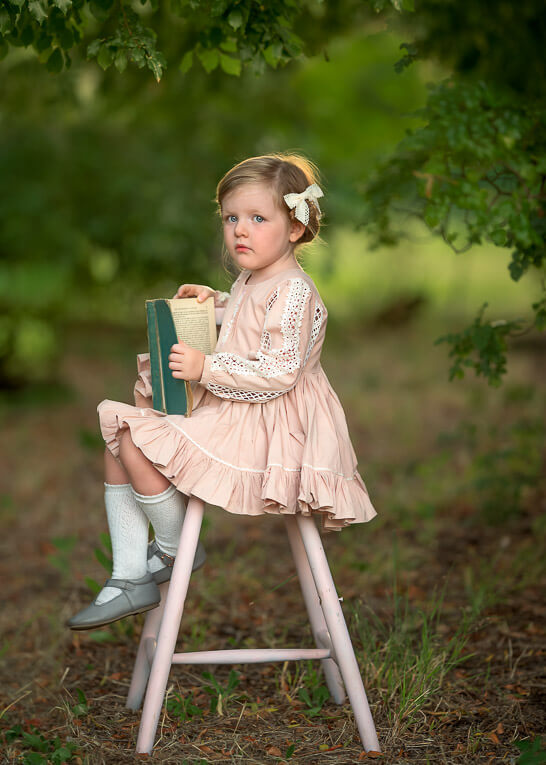 3 year old Perth girl holding book during photoshoot