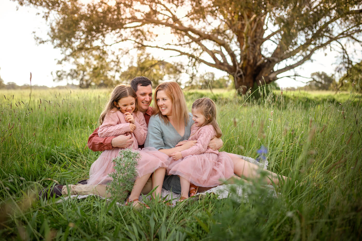 Perth family tickling each other during outdoor photo session at Lilac Hill, Guildford