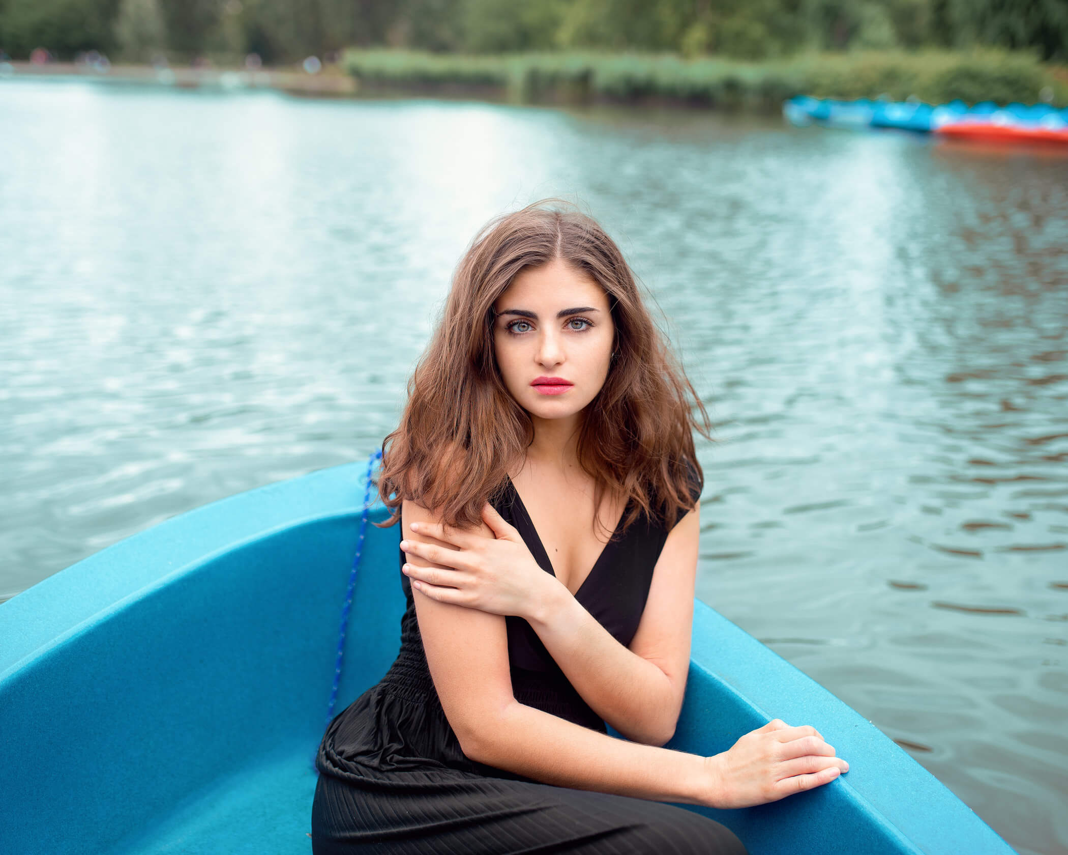 A women sitting on a boat at London's Hyde Park