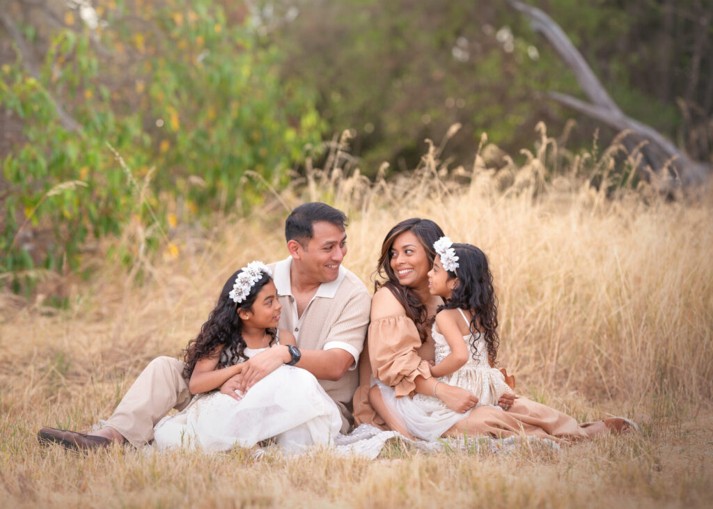 Perth parent sitting and holding kids during an outdoor family photography session at Perry's Paddock
